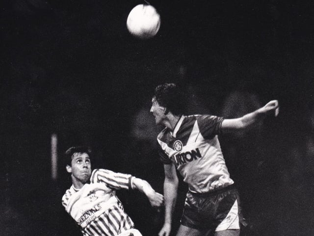 John Pearson wins an aerial duel in the goalless draw against Huddersfield Town at Leeds Road in September 1987.