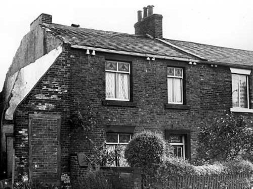 September 1972. A through terraced property on Upper Wortley Road displaying the name 'Rose Cottage' above the front door . On the left can be seen the remains of a demolished property.