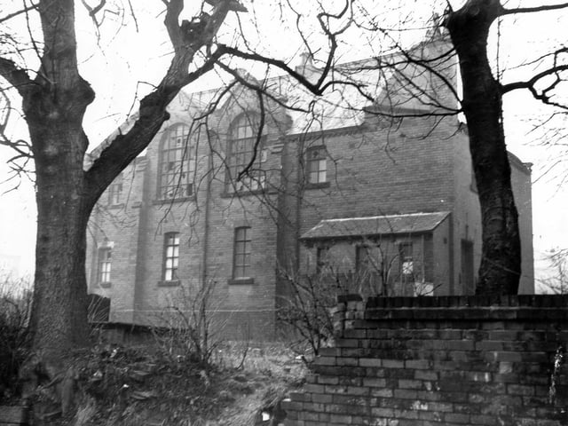December 1972. A side view of a large building with broken windows once the premises of the Boys Briggade (27th Leeds Company). This building is located at the junction of Upper Wortley Road and Churchill Street.