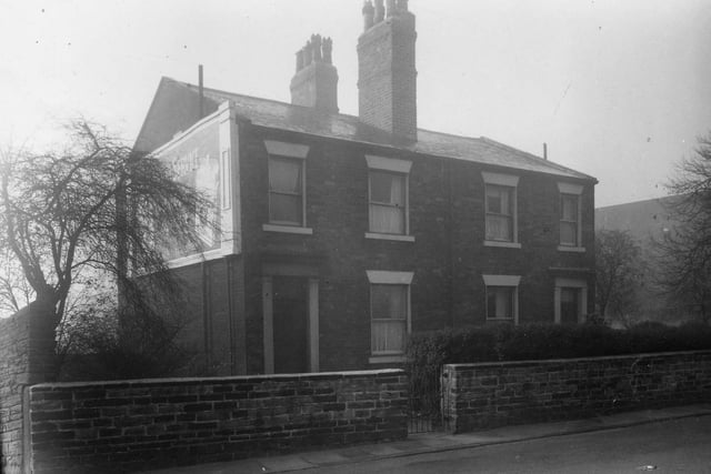 November 1959 and this photo shows a pair of houses on Burley Road. The embankment for the Leeds-Harrogate railway line can be seen on the right.