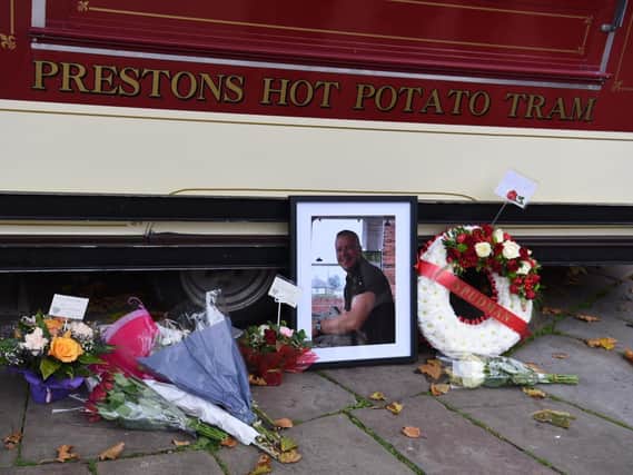 Flowers and tributes adorn the Guild Tram from which Keith Roberts served his famous hot potatoes and parches peas in Flag Market, Preston