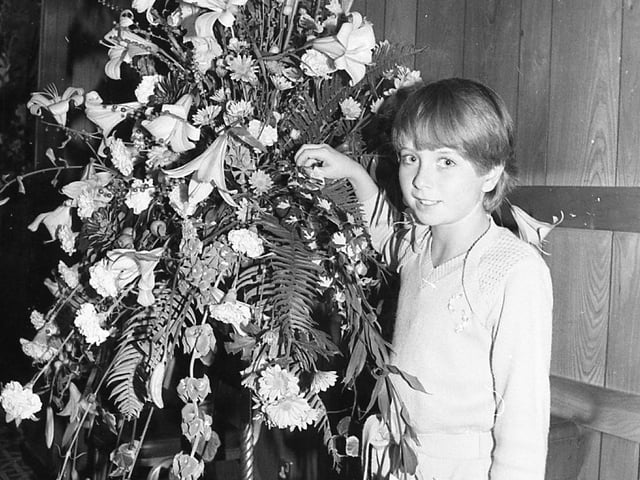 Slump-hit Blackpool was blooming again... thanks to a dazzling display of flower power. Crowds packed into the resort's Imperial Hotel to watch the pick of Britain's florists at work. Pictured is ten-year-old Lisa Shuck with one of the winning exhibits at the Interflora Florist of the Year contest