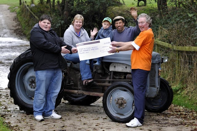 Handing over the proceeds of the Ayton charity tractor run for Martin House Hospice, with Henry the vintage grey tractor.