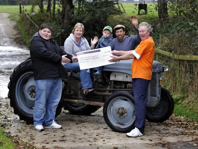Handing over the proceeds of the Ayton charity tractor run for Martin House Hospice, with Henry the vintage grey tractor.