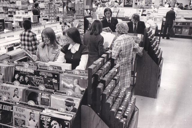 Part of the record display in the music department which was spinning along as an even bigger and better attraction for young and old in September 1973.