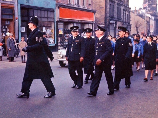 A procession to mark 75 years of Morley as a Borough as it rounds the corner from Queen Street into Wesley Street, by Boots the chemist and the private Silver Library.