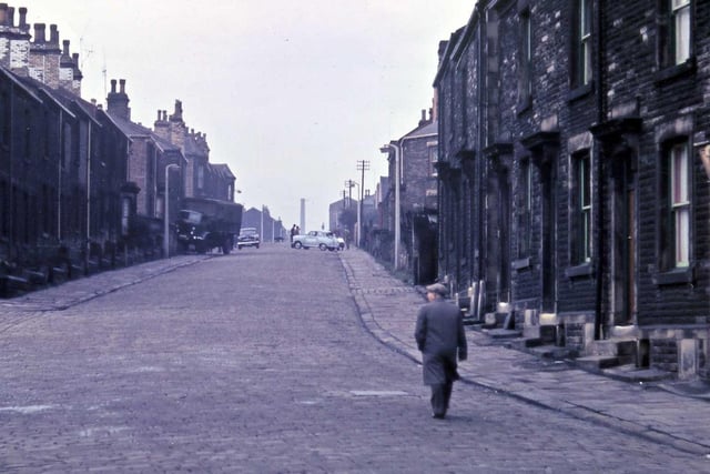 Looking up Ackroyd Street from the doorway of Morley Friends' Adult School. Cobblestones still cover the road surface and there appears to have been an accident up the street.
