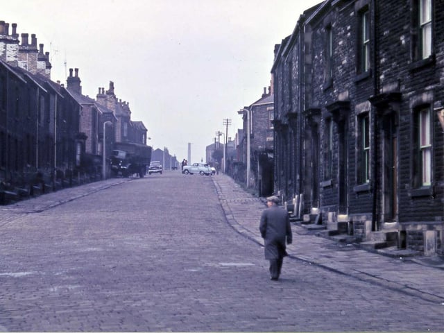 Looking up Ackroyd Street from the doorway of Morley Friends' Adult School. Cobblestones still cover the road surface and there appears to have been an accident up the street.