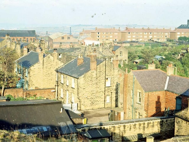 The backs of houses in High Street are seen going diagonally across the photograph from the bottom right-hand corner to the top left. The photo was taken from the top of a spoil heap resulting from quarry workings.