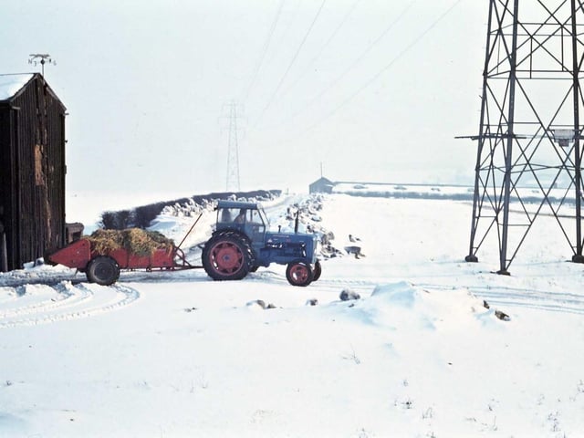 Winter farm activity at Laneside Farm, Victoria Road. The tractor is most likely spreading manure on the fields to supplement earlier winter sown grain.