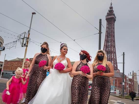 Bride Rosie Graham walks along the Promenade with her bridesmaids wearing face masks