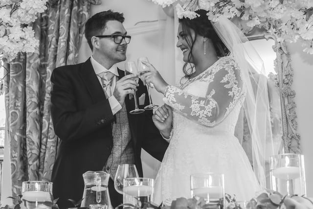 The couple toast their marriage at the reception