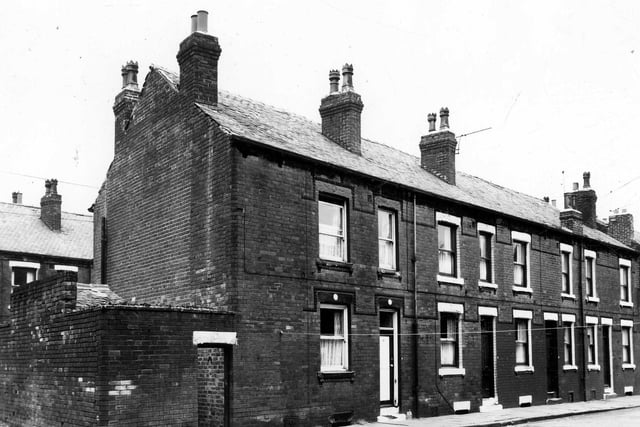 This is Ashton Terrace in August 1963. On the left is access to Windsor Place with a yard on the right, originally built to house the shared outside toilet.