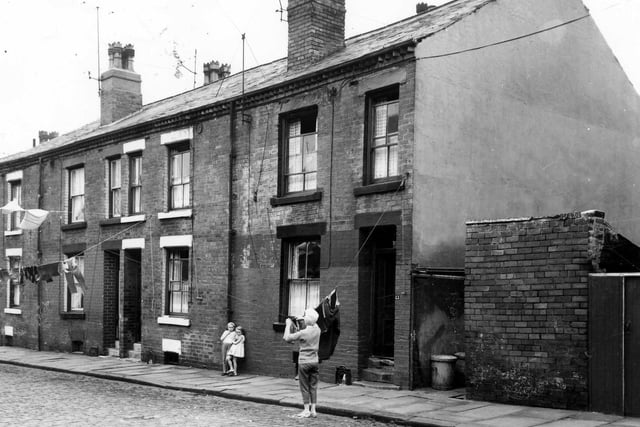 Four back-to-back terraced houses on Dunbar Street with a yard on the right originally built to house the shared outside toilet. Pictured in September 1964.
