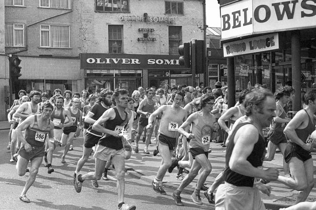 Runners compete in a road race through Wigan in 1976