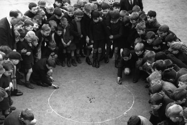 School boys competing in a game of marbles, the winner would take part in a championship contest at Castleford's 'Reight Neet Aht', part of which would be broadcast.