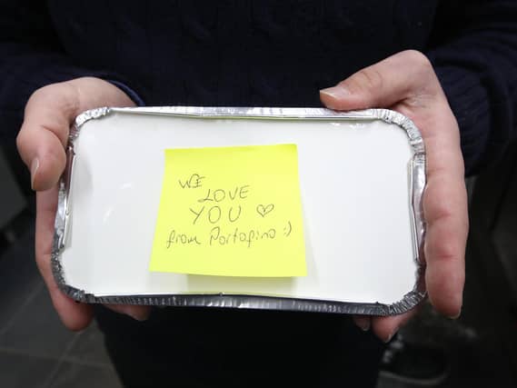 Ozgur Babat, owner of the Portofino restaurant, with a food box which they will be handing out free during half term (Photo: PA Wire/Danny Lawson)