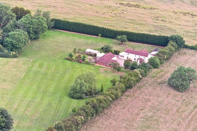 Another listing that is offering two homes for the price of one - a detached bungalow and detached house. There are also double detached garages, two stables and a log cabin up for grabs.