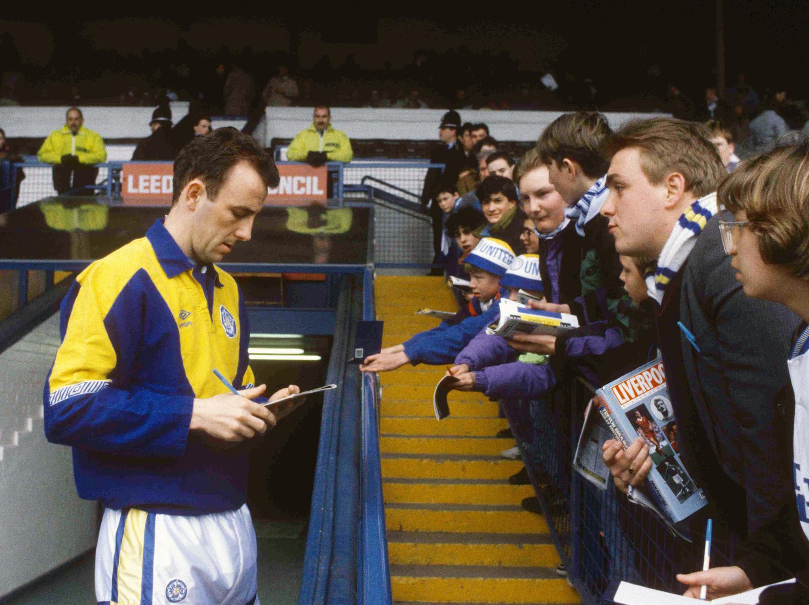 Gary McAllister signs autographs for Leeds United fans at Elland Road.