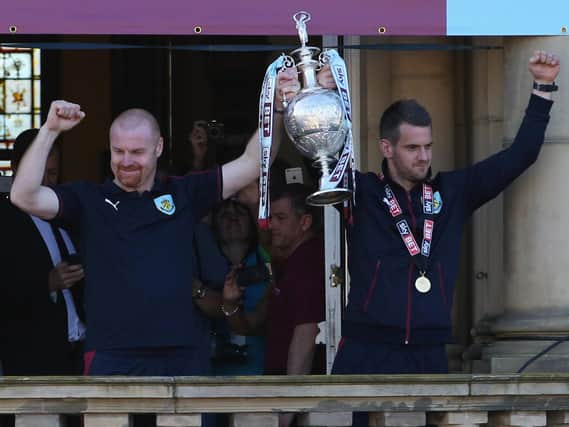 Burnley boss Sean Dyche and former club captain Tom Heaton celebrate with the trophy as Sky Bet champions Burnley are presented with the Championship trophy in 2016.