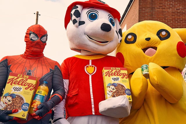 Spiderman, paw patrol and picachu holding some of their donated foods