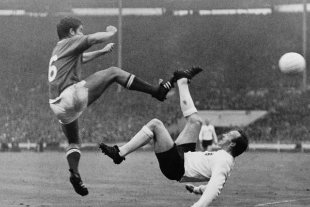 French football player Robert Budzynski (L) kicks the ball against his British opponent Nobby Stiles (Norbert Stiles,R) on July 20, 1966, during the match France / England of the football World Cup, at the Wembley Stadium