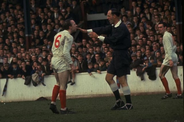 1960: Nobby Styles #6 of Manchester United has a disagreement with the referee during a match against West Ham.