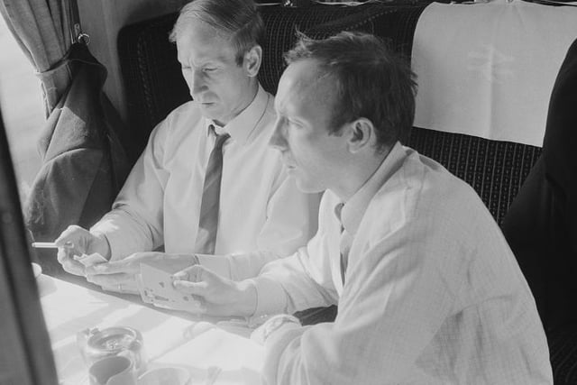 Manchester United FC soccer players Bobby Charlton and Nobby Stiles playing poker on a train, 27th May 1968