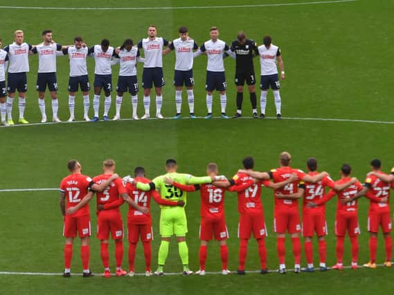Both sets of players observe a minute's silence for football legend Nobby Stiles.