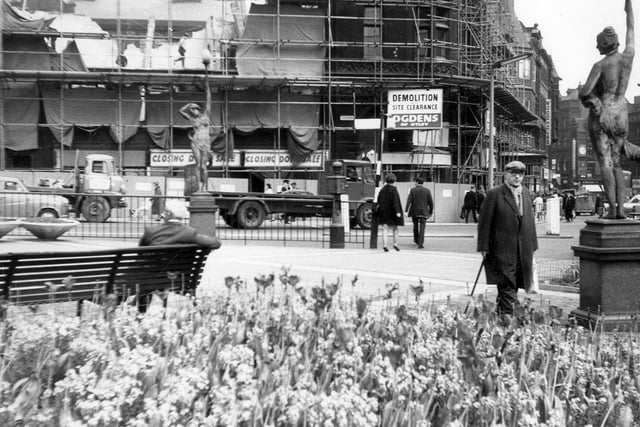 City Square showing the demolition taking place of the Royal Exchange Buildings at number 1A Park Row in May 1964. A tower block replaced the buildings in 1965. In the foreground, right, is one of the figure lamps representing Morn and Eve by sculptor Alfred Drury.