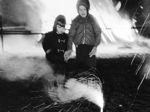 November 1969 and four-year-old Roy Rix and brother David, six, watch a firework in action at the Westwood County Primary School bonfire in Middleton.