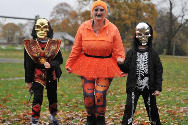 Volunteer Carol Graham, centre, with two spooky runners.