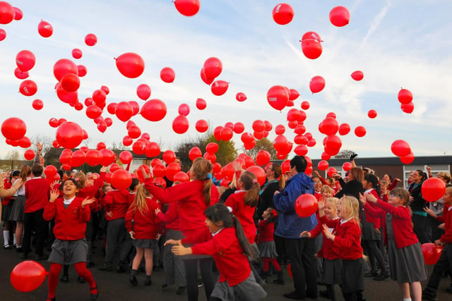 Staff and pupils at St James' Primary School, Worsley Mesnes release red balloons to commemorate Armistice Day and to pray for peace in 2016.