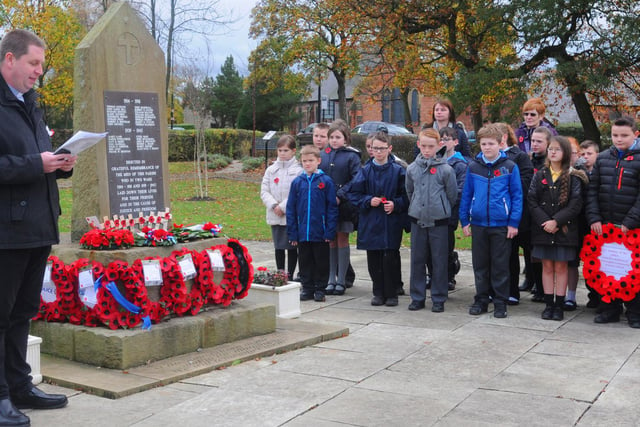 Rev David Gerrard with children from Shevington Community Primary School, during the Armistice Day memorial event at Shevington Memorial Park and Garden to lay a handmade wreaths in 2012.