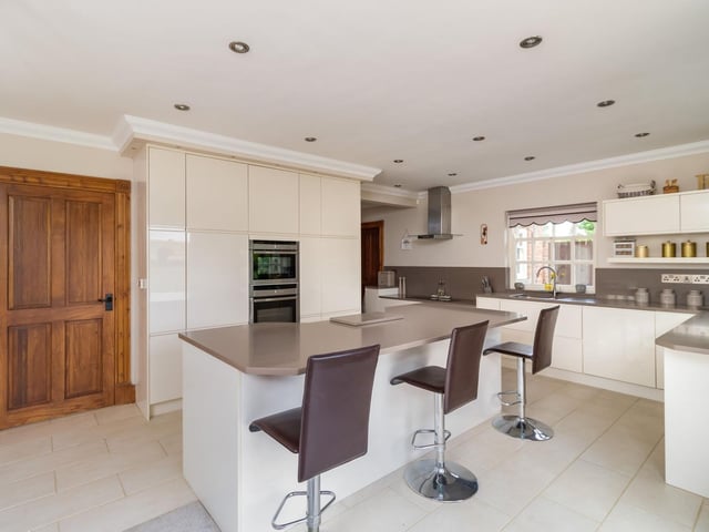 The spacious kitchen with breakfast bar