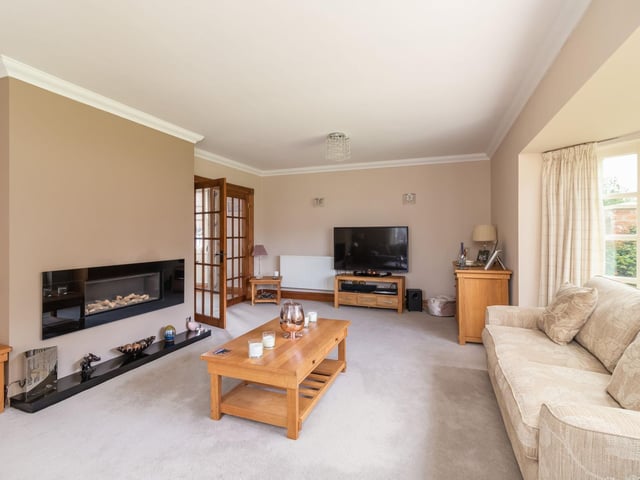 The spacious living room with feature fire place
