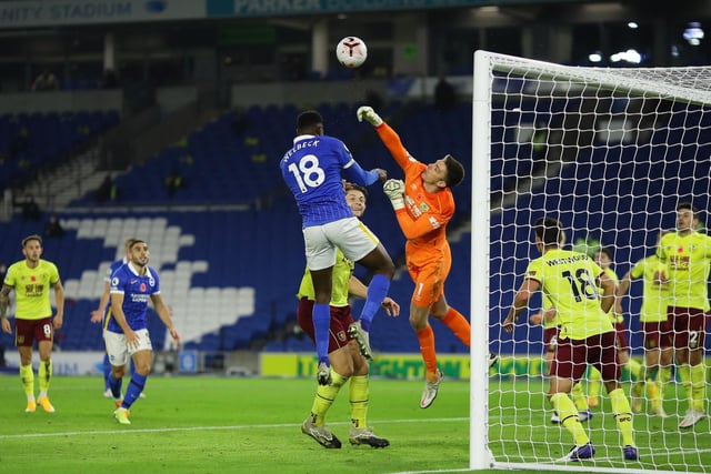 Nick Pope of Burnley punches the ball clear from Danny Welbeck of Brighton and Hove Albion during the Premier League match between Brighton & Hove Albion and Burnley at American Express Community Stadium on November 06, 2020 in Brighton, England.