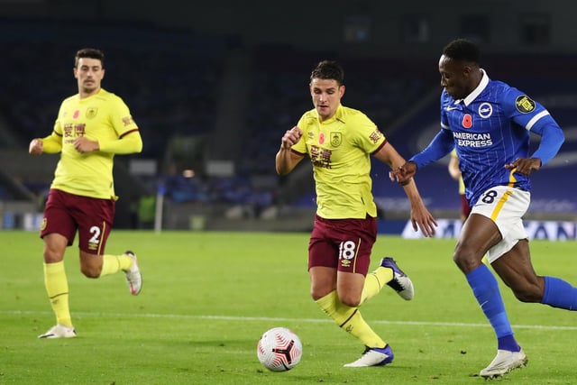 Danny Welbeck of Brighton and Hove Albion runs with the ball under pressure from Ashley Westwood of Burnley during the Premier League match between Brighton & Hove Albion and Burnley at American Express Community Stadium on November 06, 2020 in Brighton, England.