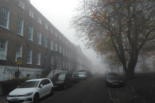 The far end of the square was hardly visible through the fog.
