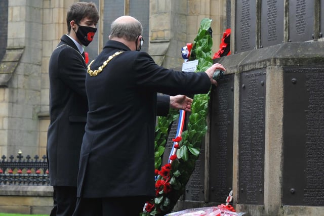 Mayor of Wigan Coun Steve Dawber lays a wreath with son and consort Oliver Waite at Wigan War Memorial.