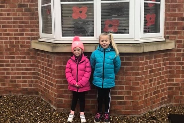 Amelia shared this photo of her daughters posing with their window display.