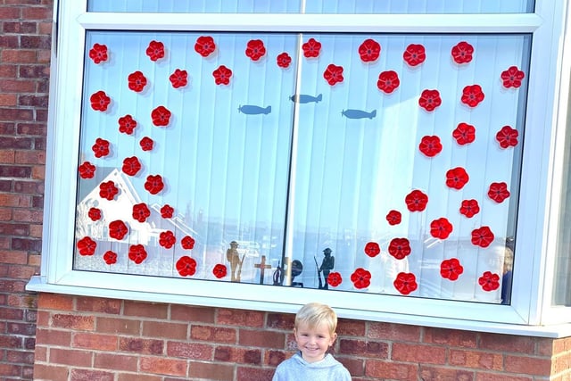 Harry Green, who is 4, outside his home in Cleveleys which was decorated with poppies and silhouettes to mark Remembrance Sunday