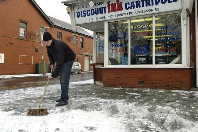 Dave Wilson from Discount Ink Cartridges clears the path in front of his Blackpool shop