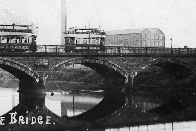 Two trams pass over the River Calder on Savile Bridge in Dewsbury. Year unknown.