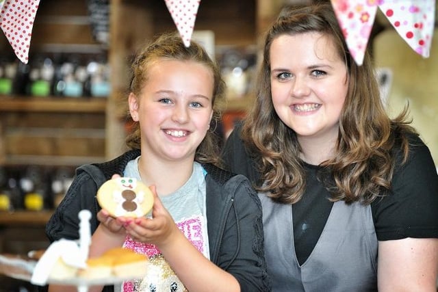Brooke Speariett (10) is helped to decorate a biscuit by Botany Bays' Gemma Dobson at Botany Bay food and drink festival, Chorley