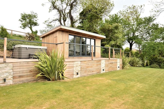 In the large garden, there is a patio area complete with Jacuzzi hot tub and a summer house complete with log burner and bi-folding doors. It is on the market with Fine & Country for £1,200,000.