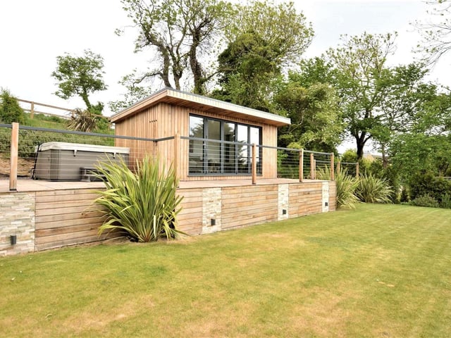 In the large garden, there is a patio area complete with Jacuzzi hot tub and a summer house complete with log burner and bi-folding doors. It is on the market with Fine & Country for £1,200,000.