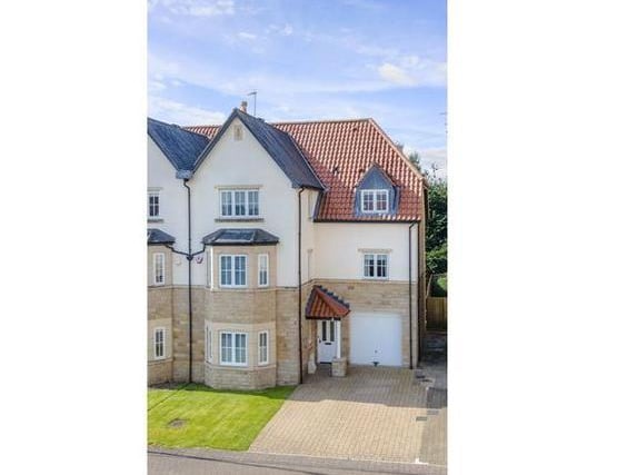 This five bedroom end townhouse sits right in the heart of the village on the River Wharfe. The light and spacious home spans three floors and has two stylish living rooms, a kitchen diner and five bedrooms.