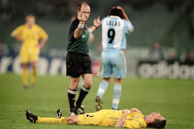 Gary Kelly lies injured during the Champions League match against Lazio in Rome's Stadio Olympico in December 2000. Leeds won 1-0.