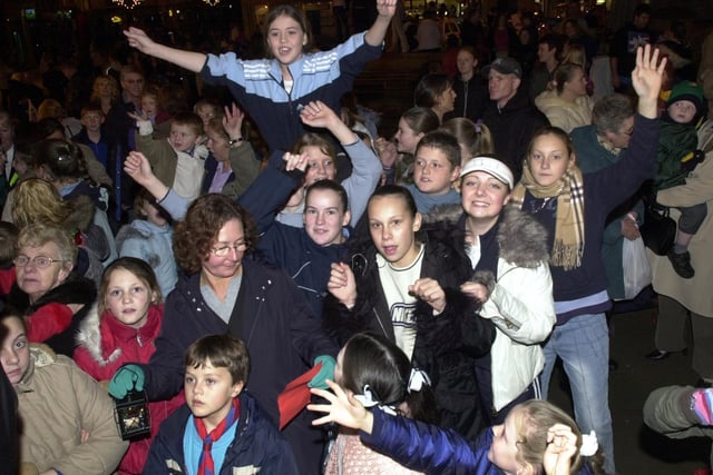An excited crowd at the Wigan Christmas lights switch on event, Market Place in 2003.